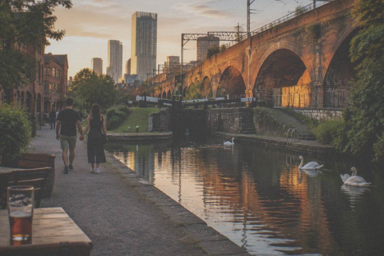 A couple walking beside the canal basins at Castlefield in Manchester at dusk